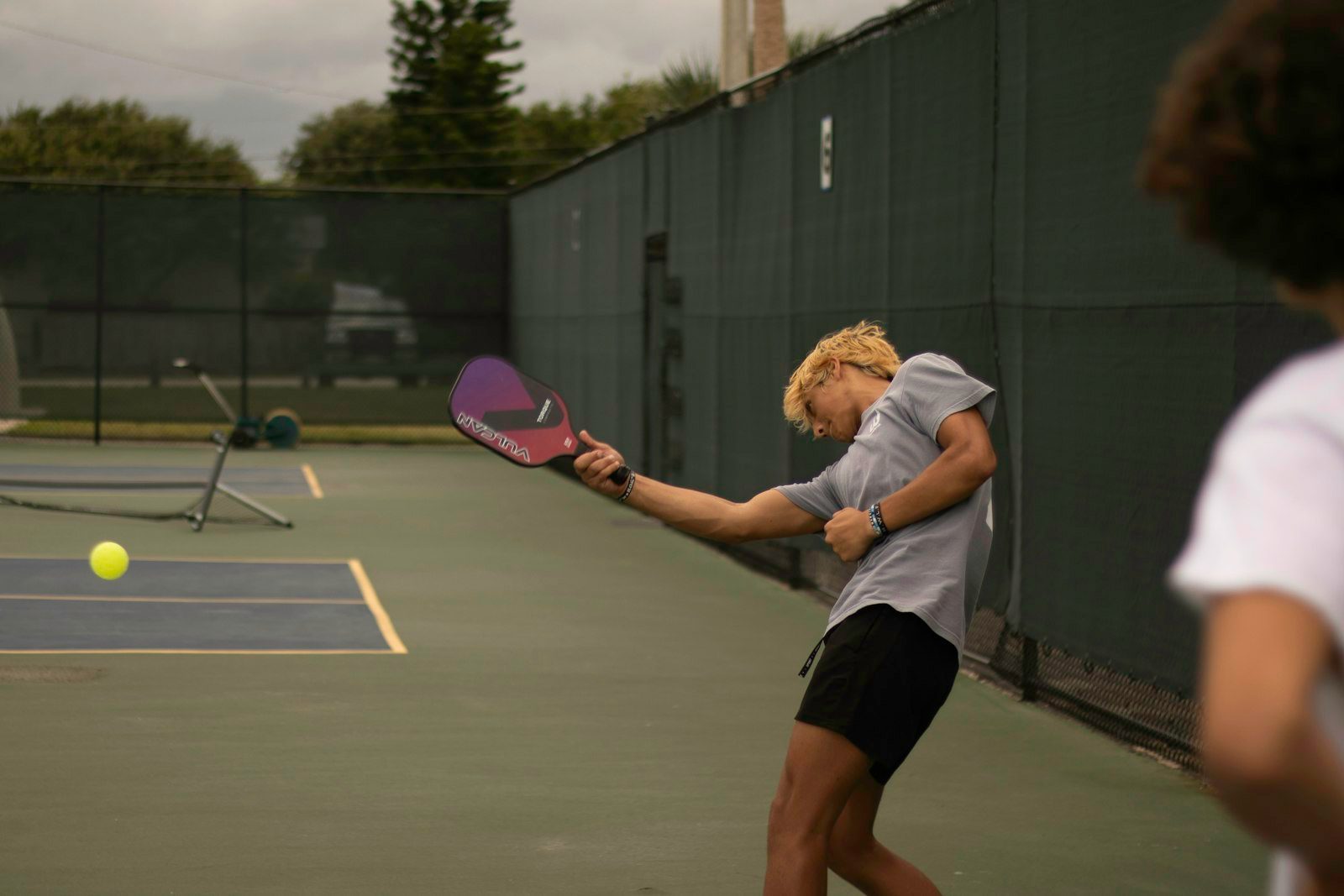 A player drives a forehand mid-rally