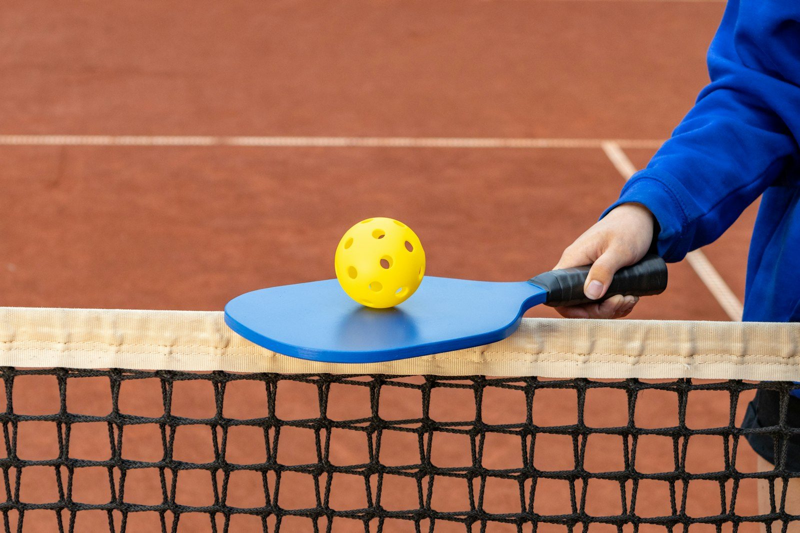 A player waits at the ready position with paddle raised